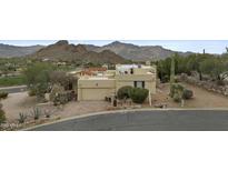 Single-story desert home with a two car garage with mature landscaping and mountain views at 6159 S Avenida Del Sol --, Gold Canyon, AZ 85118