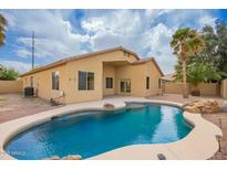 Inviting backyard with a sparkling pool, lush landscaping, and a private outdoor space perfect for entertaining at 2156 E Aloe Pl, Chandler, AZ 85286