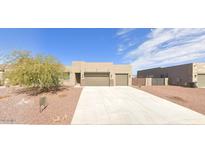 Single story home with a desert landscape, spacious driveway and a two-car garage with a covered entrance at 10298 W Morgan Ct, Casa Grande, AZ 85194