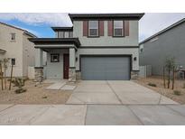 Two-story house with gray siding, brown accents, and a two-car garage at 2646 E Bluff Spring Ave, Apache Junction, AZ 85119