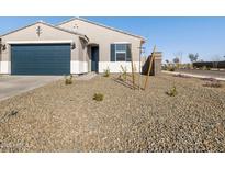 Newly built home with desert landscaping and a two-car garage at 16006 W Cottontail Ln, Surprise, AZ 85387