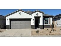 New two-story home with gray garage door and landscaping at 39980 W Agave Rd, Maricopa, AZ 85138