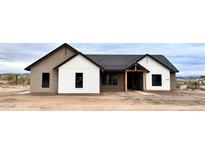 Charming single-story home featuring a modern farmhouse design with clean lines and mixed siding accents at 1716 W Lucky Ln, Queen Creek, AZ 85144