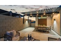 An elegant outdoor patio featuring dining and seating areas under a stylish pergola, perfect for evening entertainment at 377 E Windsor Ave # 21, Phoenix, AZ 85004