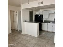 Bright kitchen with white cabinets, grey counters, and stainless steel sink offers modern amenities at 18202 N Cave Creek Rd # 107, Phoenix, AZ 85032