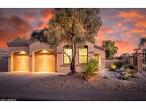 Beautiful desert landscaping and a two-car garage highlight this inviting home's exterior at 6847 S St Andrews Way, Gilbert, AZ 85298