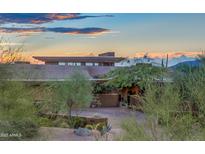 Stunning home exterior with desert landscaping at sunset at 9216 E Sky Line Dr, Scottsdale, AZ 85262