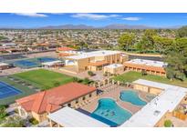 Aerial shot of Sunland Village's amenities: pool, clubhouse, tennis courts, and scenic views of the community at 4019 E Calypso Ave, Mesa, AZ 85206