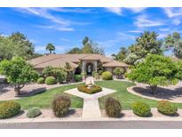 Beautiful single-story home featuring a well-manicured front yard, fountain, and a decorative entry at 4222 E Brown Rd # 31, Mesa, AZ 85205