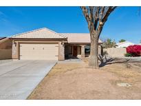 Charming single-story home with a tile roof, two-car garage, and a desert-landscaped front yard at 3202 E Decatur St, Mesa, AZ 85213