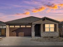 Charming single-Gathering home featuring a two-car garage, stone accents, and a modern design at 36944 W Prado St, Maricopa, AZ 85138