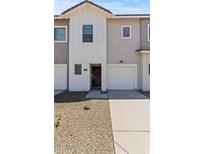 Charming townhome with a single-car garage, well-kept front yard, and inviting entrance at 7449 S 75Th Dr, Laveen, AZ 85339