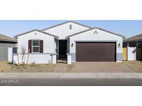 One-story home with a two-car garage and desert landscaping at 17744 W Coolidge St, Goodyear, AZ 85395