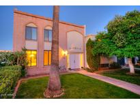 Brick building exterior with a lush lawn and walkway at 7662 E Minnezona Ave, Scottsdale, AZ 85251