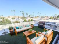 Relaxing rooftop patio with seating area, grill, and city views at 7662 E Minnezona Ave, Scottsdale, AZ 85251