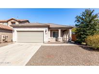 Charming single-story home with a two car garage and well-maintained landscaping at 26058 W Yukon Dr, Buckeye, AZ 85396