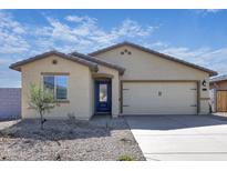 Charming single-story home with desert landscaping, a two-car garage, and a welcoming blue front door at 24593 W St Catherine Ave, Buckeye, AZ 85326