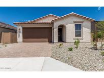 Charming single-story home with a brown garage door and brick paver driveway at 18532 E Dario Rd, Gold Canyon, AZ 85118
