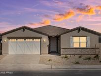 Charming single-story home featuring a two-car garage and professionally landscaped front yard at 37014 W La Paz St, Maricopa, AZ 85138
