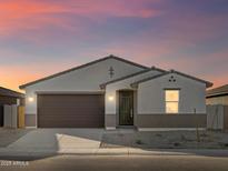 New construction home with a two-car garage and desert landscaping at 37421 W San Clemente St, Maricopa, AZ 85138