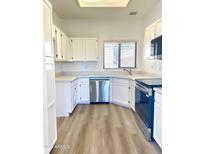 Bright kitchen featuring white cabinets, stainless steel appliances, and modern countertops at 19400 N Westbrook Pkwy # 311, Peoria, AZ 85382