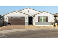 Single story home with brown garage door and landscaping at 4030 S 177Th Ave, Goodyear, AZ 85338