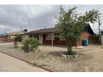 Charming single-story brick home featuring a quaint front yard and covered porch at 4232 W Citrus Way, Phoenix, AZ 85019