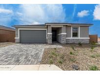 Charming single-story home features a gray brick driveway and stucco exterior with stone accents at 18605 E Panchito Dr, Gold Canyon, AZ 85118