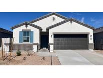 Charming single-Gathering home featuring a gray roof, stucco siding, desert landscaping and a spacious two-car garage at 25316 W Sunland Ave, Buckeye, AZ 85326