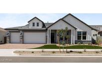 Beautiful two-story home with a manicured lawn and a three-car garage at 1042 W Ridge Rd, Apache Junction, AZ 85120