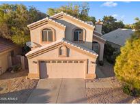 Charming two-story home featuring a two-car garage and a meticulously maintained, low maintenance landscaped yard at 1448 W Shellfish Dr, Gilbert, AZ 85233