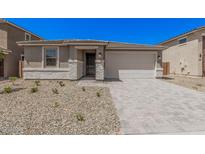 Charming single-story home with a two-car garage, stone accents, and low-maintenance desert landscaping at 18762 E Panchito Dr, Gold Canyon, AZ 85118