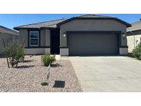 Charming single-story home with a two-car garage and low-maintenance desert landscaping at 38155 W Excussare Way, Maricopa, AZ 85138