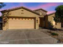 Charming single-story home featuring a two-car garage and desert landscaping at 4548 E Carob Dr, Gilbert, AZ 85298