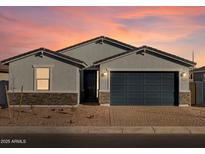 Single-story home with gray exterior, dark garage door, and stone accents at 4314 W Josephine St, San Tan Valley, AZ 85144