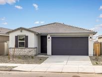 Charming single-story home with a two-car garage, stone accents, and desert landscaping at 16017 W Cottontail Ln, Surprise, AZ 85387