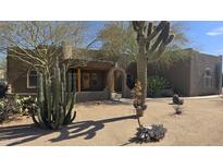 Inviting desert home featuring native landscaping and a charming front porch entrance with a welcoming wreath at 2926 W Tanya Trl, Phoenix, AZ 85086