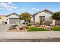 Single-story home with landscaped front yard, two-car garage, and attractive curb appeal at 27078 W Yukon Dr, Buckeye, AZ 85396