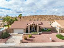 Charming single-story home featuring a tile roof, two-car garage, and low-maintenance desert landscaping at 1017 E Grandview Rd, Phoenix, AZ 85022