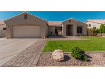 Charming single-story home featuring a well-manicured lawn and tile roof at 22364 N 67Th Dr, Glendale, AZ 85310