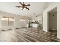 Open-concept living space with gray vinyl floors, neutral color palette, and seamless flow into the kitchen area at 6658 E San Cristobal Way, Gold Canyon, AZ 85118