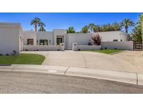 Modern home with expansive driveway and landscaped lawn at 9027 N 82Nd St, Scottsdale, AZ 85258
