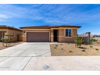 Single-story home featuring a two-car garage, low-maintenance landscaping, and a neutral color palette at 18197 W Cielo Grande Ave, Surprise, AZ 85387