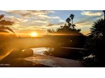 Stunning sunset view from the pool area with palm trees and beautiful sky at 4836 E White Gates Dr, Phoenix, AZ 85018