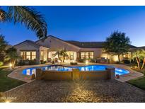 Luxury home with a large pool, fire pit, and outdoor kitchen at 2086 E Mead Dr, Gilbert, AZ 85298