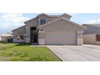 Two-story house with attached garage and well-maintained lawn at 1207 N Velero St, Chandler, AZ 85225