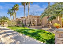 Beautiful desert home with lush landscaping, sidewalk and verdant green lawn at 4301 E Taurus Pl, Chandler, AZ 85249