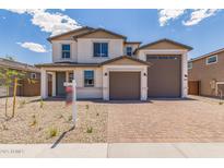 Charming two-story home featuring a three-car garage and desert landscaping, perfect for curb appeal at 18711 E Panchito Dr, Gold Canyon, AZ 85118