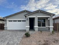 Charming single-story home features a two-car garage, stone accents, and low-maintenance desert landscaping at 40025 W Elm Dr, Maricopa, AZ 85138