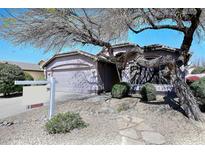 Charming single-story home featuring a low-maintenance desert landscape and a two-car garage at 4506 E Lone Cactus Dr, Phoenix, AZ 85050